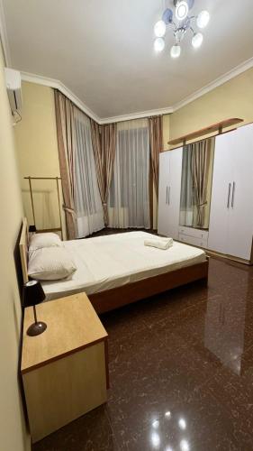 a bedroom with a large bed in a room at Village Taste Guest House in Buzovna