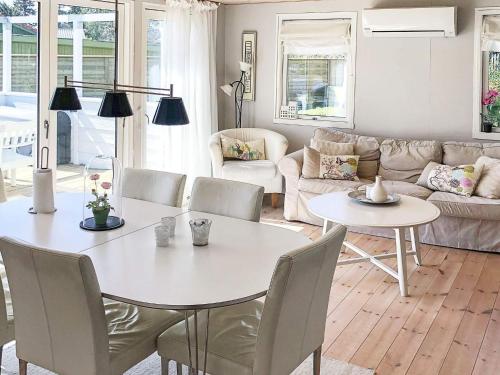 a living room with a white table and chairs at 6 person holiday home in Væggerløse-By Traum in Marielyst