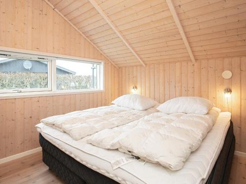 a large bed in a room with a window at 6 person holiday home in Vinderup-By Traum in Vinderup