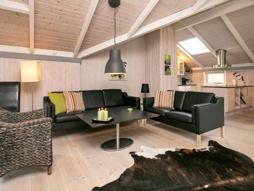 a living room with a couch and a table at 8 person holiday home in Ålbæk-By Traum in Ålbæk