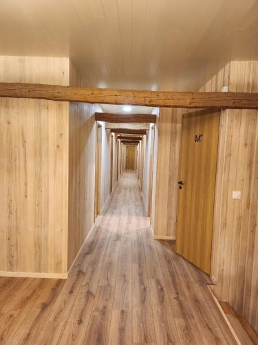 a long hallway with wood floors and a door at Talu villa 