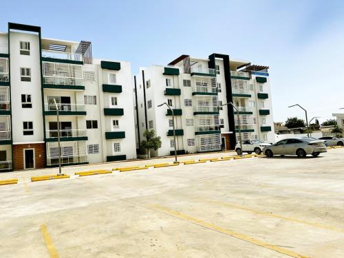 a parking lot in front of a large building at Ideal space for the family in Boca Chica