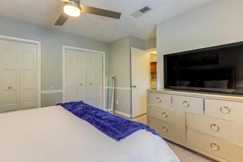 a bedroom with a bed and a flat screen tv at Steps to Park Dog-Friendly Condo in Conyers! in Conyers
