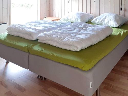 a bed with two white pillows on top of it at 10 person holiday home in Ansager in Ansager