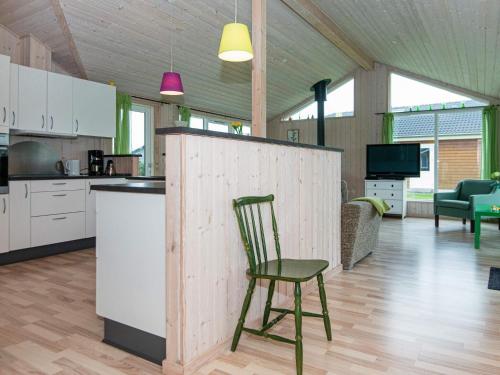 a kitchen with a chair in the middle of a room at 10 person holiday home in Ansager in Ansager