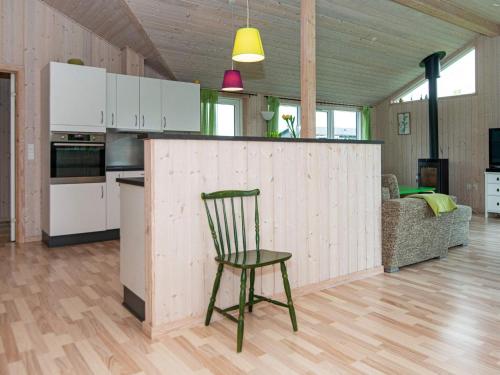 a wooden bar in a kitchen with a chair in a room at 10 person holiday home in Ansager in Ansager