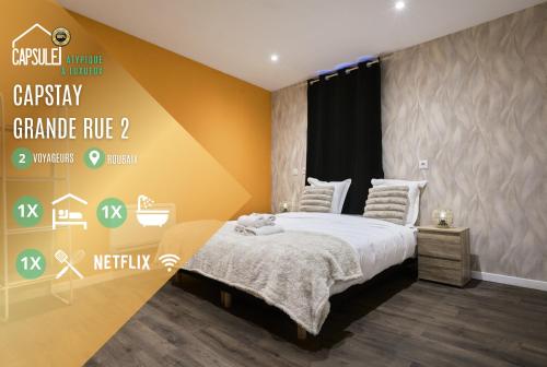 a bedroom with a bed and a yellow wall at Capstay - Roubaix - Grande Rue l Netflix - Wifi in Roubaix