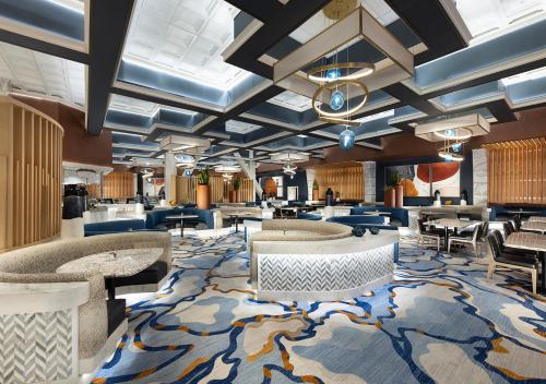 a lobby with couches and tables and a rug at Rainbow Hotel Casino by Peppermill Resorts in West Wendover