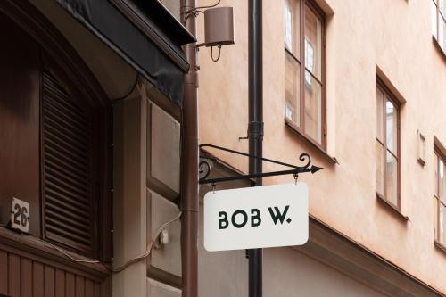 a sign that says bobwx hanging on a building at Bob W Stockholm Gamla Stan in Stockholm