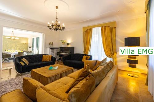 a living room with a couch and a table at Luxury Villa EMG Steinfurt Münster Enschede - Steinfurt in Steinfurt