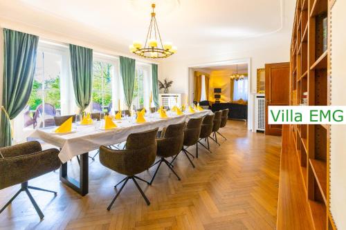 a long dining room with a long table and chairs at Luxury Villa EMG Steinfurt Münster Enschede - Steinfurt in Steinfurt