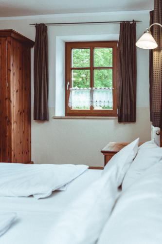 a bedroom with a bed and a window at Landhotel Kahrmühle in Pressath