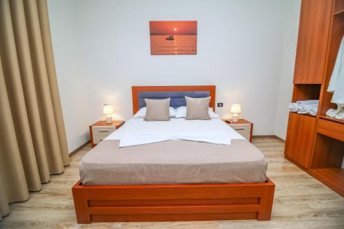 a bedroom with a large bed with two night stands at The Blue House in Široka