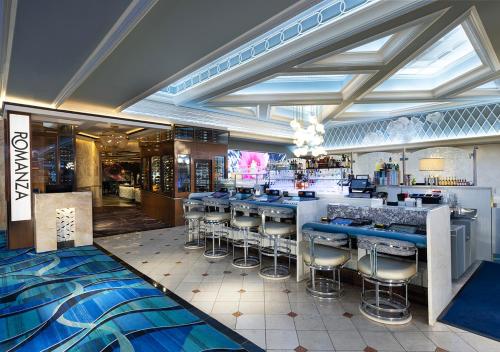 a bar in a restaurant with blue stools at Montego Bay Resort Casino by Peppermill Resorts in West Wendover