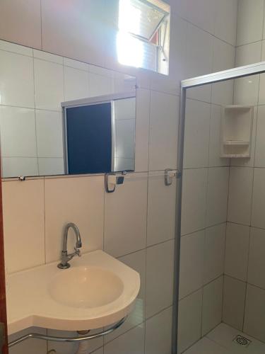 a bathroom with a sink and a mirror at Pousada Kalango in Barra Grande