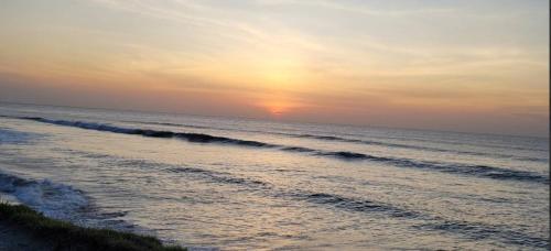 a sunset on the beach with the ocean at 2br Apartamento con Vista al Mar Ph Rio Mar T1-11A in San Carlos