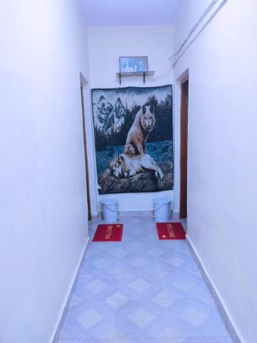 a painting of a dog on a wall in a hallway at Xavier's guesthouse Wi-Fi and Villa in Colva
