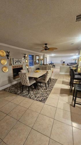 a large living room with a table and chairs at Jacksonville Waterfront Retreat 3BR 3BA Fishing Dock River Views in Jacksonville