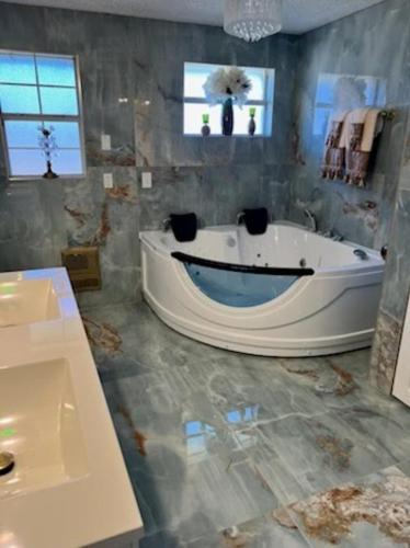 a large bathroom with a tub and a sink at Jacksonville Waterfront Retreat 3BR 3BA Fishing Dock River Views in Jacksonville