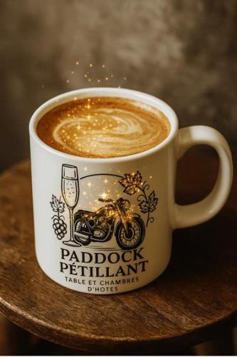 a cup of coffee sitting on top of a table at paddock pétillant in Auménancourt-le-Grand