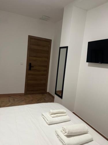 a bedroom with two towels on a bed with a television at HAD Valencia in Valencia