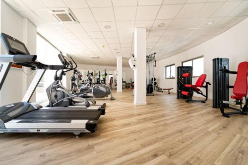 a gym with treadmills and elliptical machines at Hotel Las Costas in Puerto del Carmen