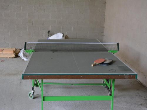 a ping pong table with a pair of scissors on it at Riverside Villa in Bouillon in Bouillon