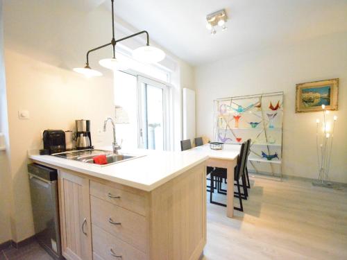 a kitchen with a sink and a counter with a table at Riverside Villa in Bouillon in Bouillon