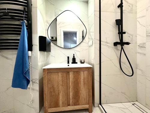 a bathroom with a sink and a mirror at Jagiellończyka Apartment - Self Check-In 20h in Wrocław