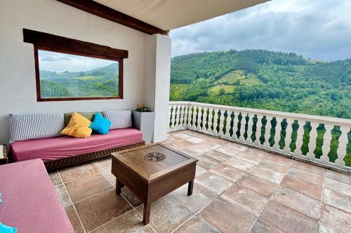 a living room with a couch and a large window at Casa Rural - La Tregua 
