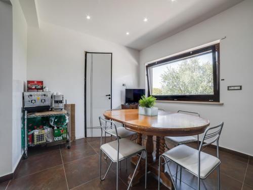 a dining room with a table and chairs and a window at Villa in Nissoria with Private Pool in Nissoria