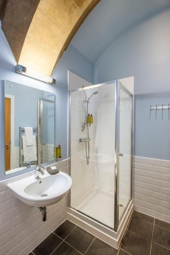 a bathroom with a sink and a shower at The Highland Club in Fort Augustus