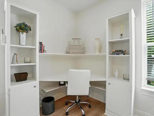 a white desk with a chair in a room at Panoramic Views -Downtown Cincinnati in Cincinnati