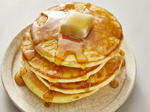 a stack of pancakes with syrup and butter on a plate at Apartment in Tröpolach near Ski Lift in Tröpolach