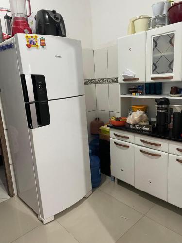 a kitchen with a white refrigerator in a kitchen at Casa para COP 30 in Ananindeua