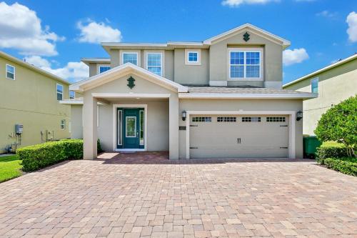 a house with a brick driveway in front of it at Luxury Home With Themed Rooms, Game Room And Waterpark & Resort Access Near Disney At Encore Resorts Reunion - 260Cl in Kissimmee