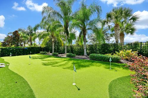 a yard with golf balls in the grass with palm trees at Luxury Home With Themed Rooms, Game Room And Waterpark & Resort Access Near Disney At Encore Resorts Reunion - 260Cl in Kissimmee