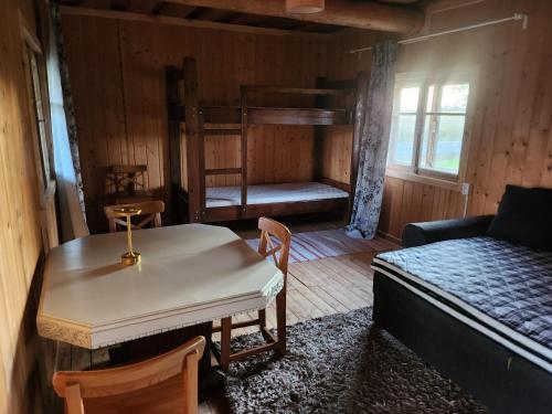 a room with a bed and a table and a bunk bed at Talu villa 