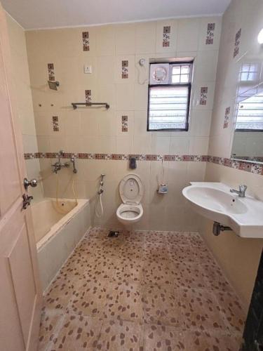 a bathroom with a sink and a toilet and a tub at ColvaPearl Deluxe Luxury Villa and Apartments Wi-Fi in Colva