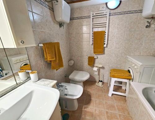 a bathroom with a white toilet and a sink at Dimora dei Consoli in Gubbio