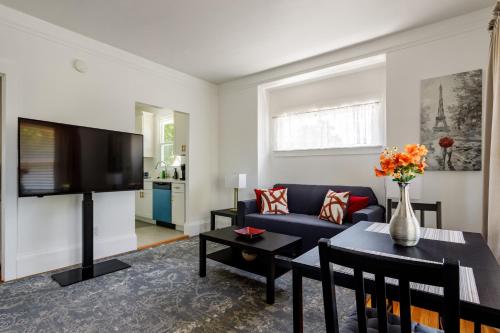 a living room with a blue couch and a tv at 3 Berkeley - 1 Bedroom Apartment, with Laundry in Berkeley