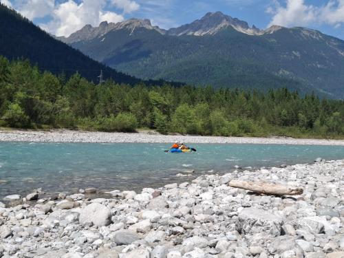 a group of people in a raft in a river at Apart Lechtraum in Stanzach