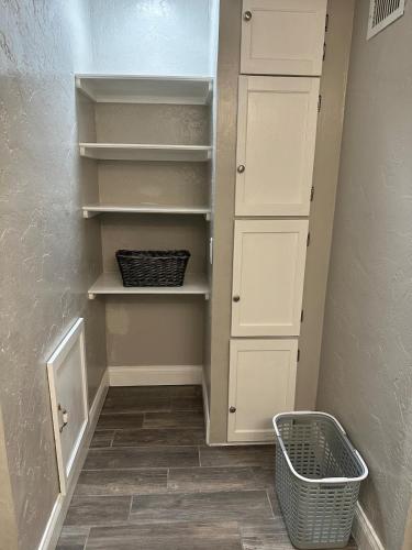 a walk in closet with white cabinets and a basket at Deland Serenity Place #1 in DeLand
