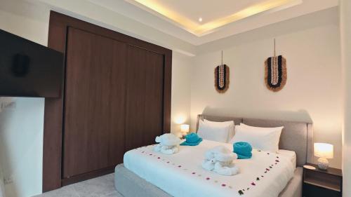 a bedroom with a bed with two teddy bears on it at Santi Tara Villas in Amphoe Koh Samui
