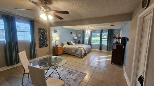 a bedroom with a bed and a table and chairs at Jacksonville Waterfront Retreat 3BR 3BA Fishing Dock River Views in Jacksonville
