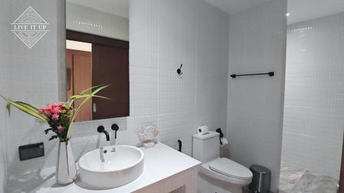 a white bathroom with a sink and a toilet at Santi Tara Villas in Amphoe Koh Samui