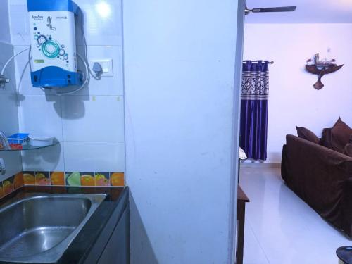 a kitchen with a sink and a couch in a room at ColvaPearl Deluxe Luxury Villa and Apartments Wi-Fi in Colva