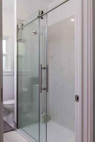 a shower with a glass door in a bathroom at 3 Berkeley - 1 Bedroom Apartment, with Laundry in Berkeley