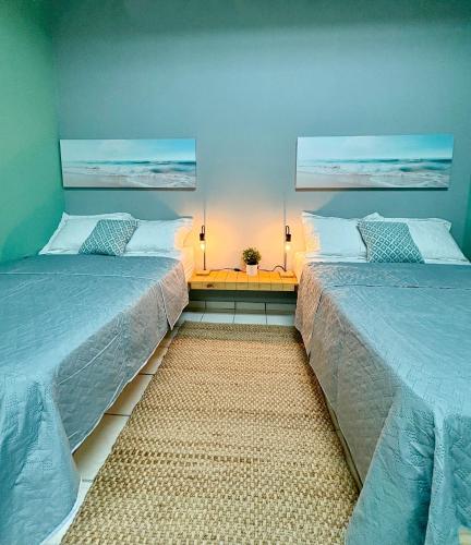two beds sitting next to each other in a bedroom at Hostel of Santurce in San Juan