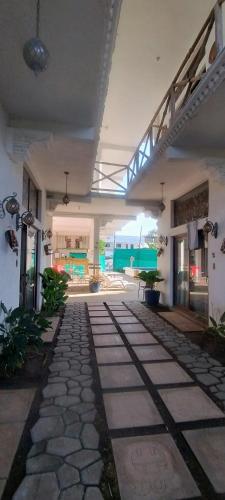 a room with a stone walkway in a building at MAYAN SURF HOTEL in El Paredón Buena Vista